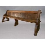 GOTHIC OAK AND ELM PEW, 19th century, with an oak panel back and ends, a one piece elm seat and