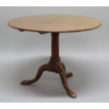 GEORGE III MAHOGANY TILT TOP BREAKFAST TABLE, the circular top on a turned column and tripod base