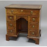 GEORGE III MAHOGANY KNEEHOLE DESK, the crossbanded top above a long frieze drawer, a shallow