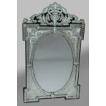 VENETIAN MIRROR, the bevelled, oval plate inside foliage engraved spandrils and beneath a