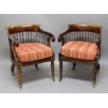PAIR OF REGENCY ROSEWOOD LIBRARY TUB CHAIRS, the rounded back above woven cane supports and