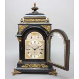 VICTORIAN EBONISED AND GILT METAL MOUNTED BRACKET CLOCK AND BRACKET, the silvered dial with 7 1/4"