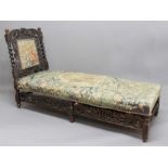 CAROLEAN STYLE OAK DAY BED, the back rest carved with a crown supported by cherubs above a