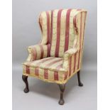 GEORGE II STYLE WALNUT WING ARMCHAIR, with outswept scrolling arms on carved, cabriole legs and ball