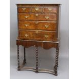 WALNUT CHEST ON STAND, early 18th century, the moulded cornice above three short and three graduated