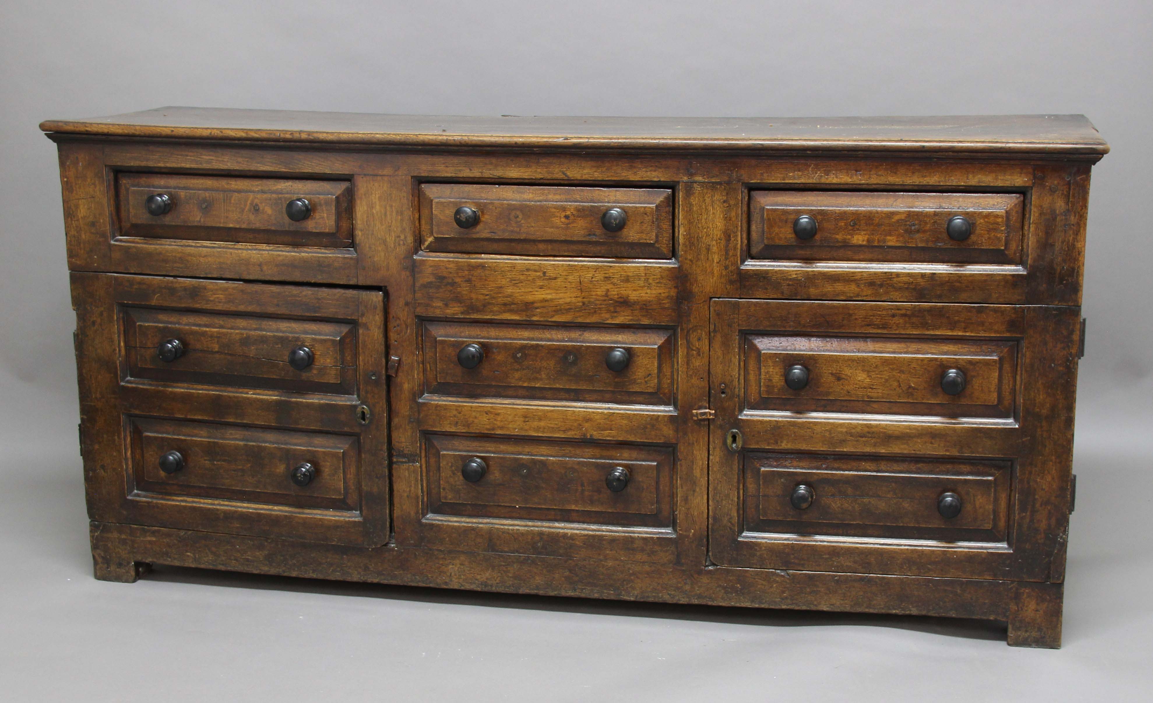 OAK DRESSER BASE, 18th century, three raised panel drawers above two double drawer height