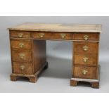 VICTORIAN WALNUT AND CROSSBANDED TWIN PEDESTAL DESK, the top with a tooled leather skillett above