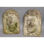 NEAR PAIR OF CARVED STONE LION MASKS, late 18th or 19th century, in arched niches, height 41cm (2)