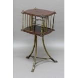 EDWARDIAN MAHOGANY AND BRASS REVOLVING BOOK TABLE, the shaped square top above four brass sections