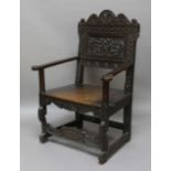 OAK WAINSCOT CHAIR, 18th century, the back carved with thistles and flowerheads above two-plank seat