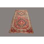 KARABAGH RUG, South Caucasus, circa 1900, the abrashed elongated octagonal rose pink field with