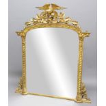 REGENCY STYLE GILTWOOD OVERMANTEL MIRROR, the arched plate beneath a spread eagle crest, flanked