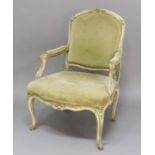 FRENCH LOUIS XV STYLE FAUTEUIL, the painted and gilded frame with carved floral highlights and green