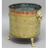 COPPER AND BRASS JARDINIERE, 19th century, with lion head handles, banded decoration and paw feet,