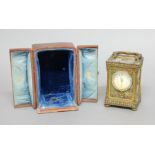 FRENCH BRASS, ONYX AND PASTE MOUNTED CARRIAGE TIME PIECE, retailed by the Goldsmith Company,