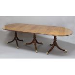 GEORGE III MAHOGANY AND BURR WALNUT THREE PILLAR DINING TABLE, the top with a pair of D ends and a
