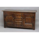 OAK DRESSER BASE, 18th century, the planked top above a single, central drawer above two matching