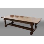 OAK REFECTORY STYLE TABLE, the cleated, four plank top above a fruiting vine frieze, fluted legs