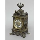 FRENCH BRASS MANTEL CLOCK, late 19th century, the dial with enamelled numerals on a brass eight