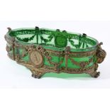 FRENCH GREEN GLASS AND GILT METAL CENTREPIECE, 19th century, the mounts with rams head handles,