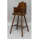 OAK CHILDS HIGH OR CORRECTION CHAIR, 19th century, the wavy back above solid arms and seat, the