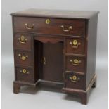 GEORGE III MAHOGANY SECRETAIRE KNEEHOLE DESK, the long top drawer opening to reveal secretaire