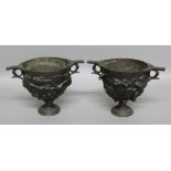 PAIR OF BRONZE TWO HANDLED URNS, 19th century, cast with fruiting foliage on a socle base, height