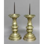 PAIR OF NUREMBERG BRASS PRICKET CANDLESTICKS, 17th century, the 10cm iron spike above circular