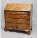 GEORGE II WALNUT BUREAU, the feather banded fall front enclosing a fitted interior with a mirrored