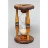 FRUITWOOD SAND GLASS, the frame with turned spindles and metal joints, height 24cm