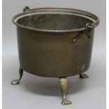 BRASS CAULDRON, 19th century, with swing handle and lion paw feet, height 43cm, diameter 50cm