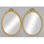 PAIR OF REGENCY STYLE GILT WALL MIRRORS, the bevelled oval plate inside reeded frames and beneath