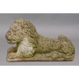 RECONSTITUTED STONE LION, recumbent with his head raised, length 66cm