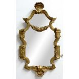 FRENCH GILTWOOD MIRROR, 19th century, the shaped plate beneath a smaller, cartouche plate, shell