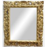 FLORENTINE STYLE GILTWOOD MIRROR, the rectangular plate inside a scrolling, foliate frame, 60cm x