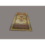 NORTH WEST PERSIAN RUG, circa 1950, the diamond lattice field with twin lemon panels, each with a