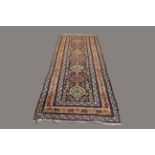 NORTH WEST PERSIAN RUNNER, circa 1900, the charcoal field with seven large octagons surrounded by