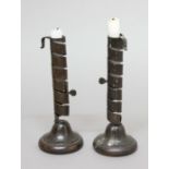 PAIR OF IRON SPIRAL EJECTOR OR COURTING CANDLESTICKS, 18th century, on wooden bases, height 21cm (