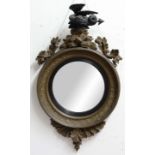 REGENCY STYLE GILT BULLS EYE MIRROR, the convex circular plate beneath a crouching dragon finial,