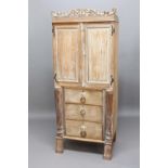 LIMED OAK LINEN PRESS, 19th century, the foliate carved cornice centred with a crown above a pair of