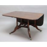 GEORGE III MAHOGANY CUMBERLAND ACTION DINING TABLE, the rounded rectangular top on a gateleg