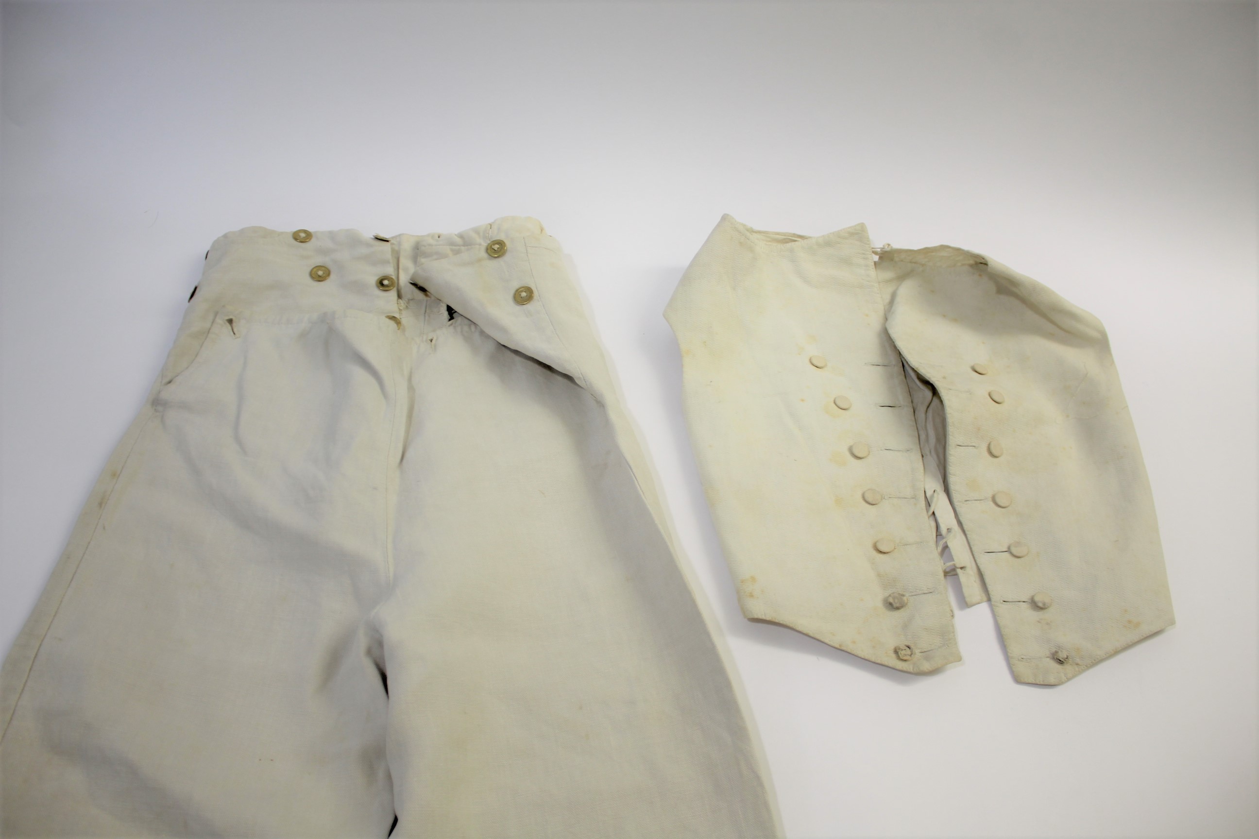 19THC GENTS TROUSERS a pair of cream linen gentleman's trousers with brass button fastening, also