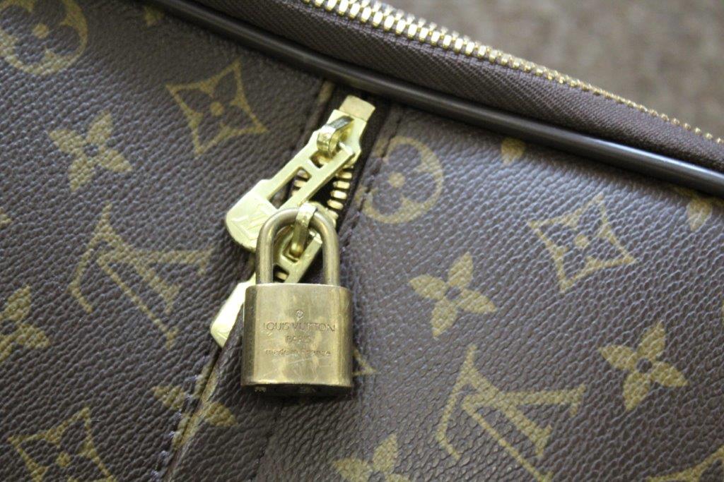 LOUIS VUITTON SUITCASE a large suitcase with monogrammed exterior and leather handles and strap, - Image 15 of 15