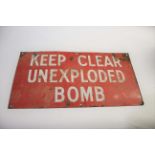 ENAMEL SIGN - UNEXPLODED BOMB a red enamel sign with white lettering, Keep Clear Unexploded Bomb.