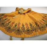 EARLY 20THC CAPE probably Eastern European, the orange wool cape lined with ivory coloured silk, and