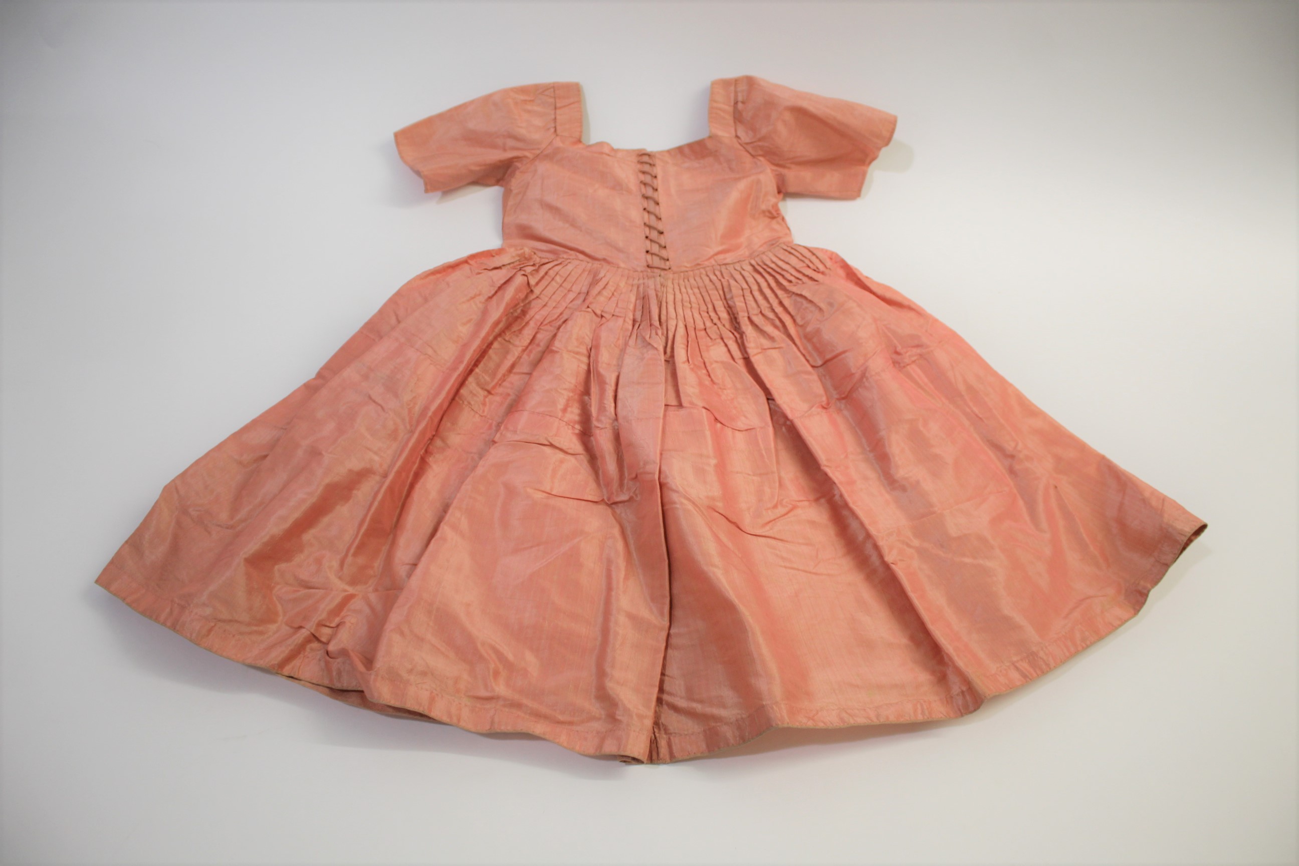 18THC SILK CHILD'S DRESS a silk child's dress, pleated to the waist with lace fastening bodice (