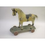 CHILDS PAINTED WOODEN PULL ALONG HORSE a vintage painted wooden model of Horse, with it's saddle and