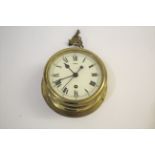 NAVAL BRASS SHIPS CLOCK a bulkhead clock with brass case and fusee movement, the white enamel dial