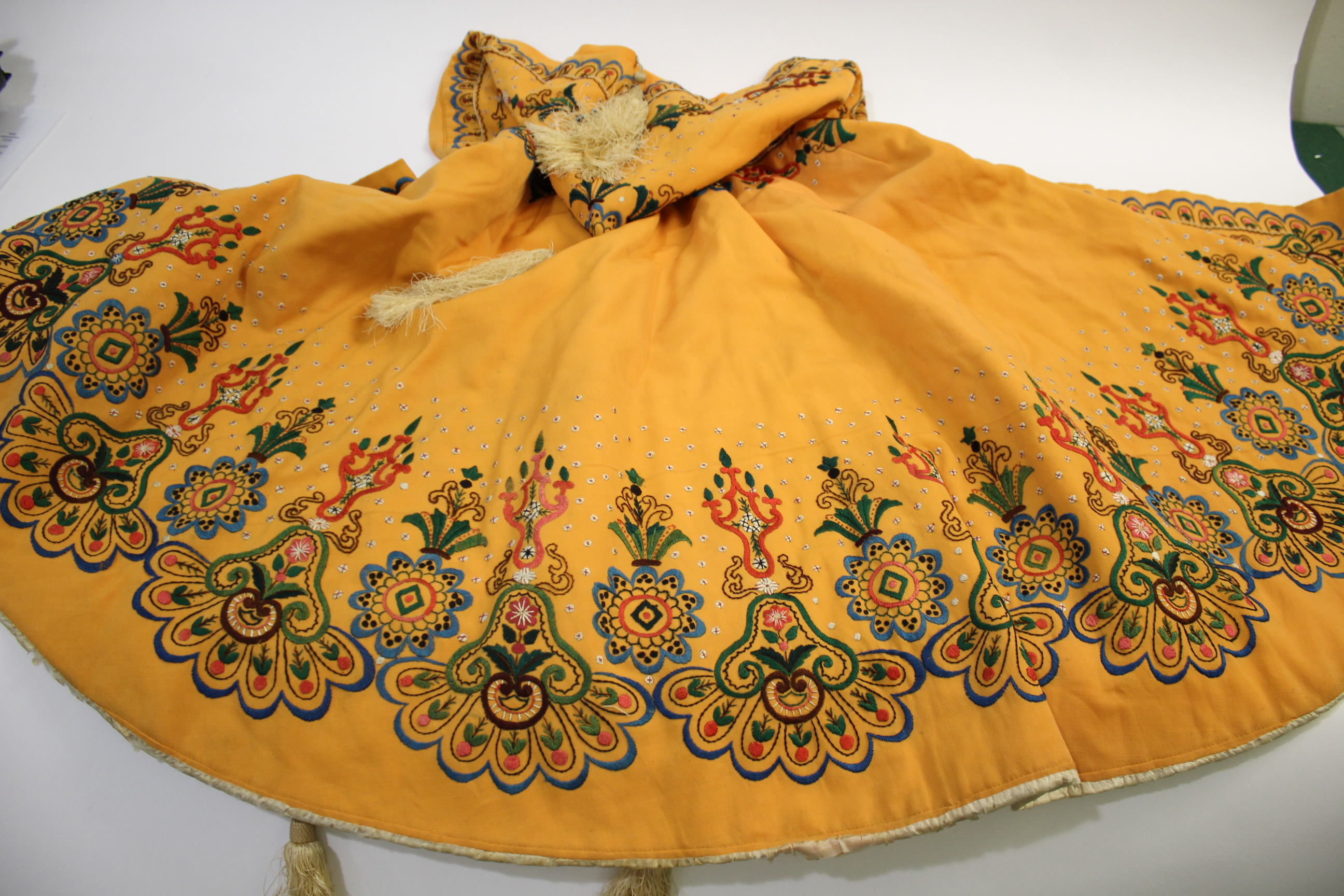 EARLY 20THC CAPE probably Eastern European, the orange wool cape lined with ivory coloured silk, and - Image 2 of 4