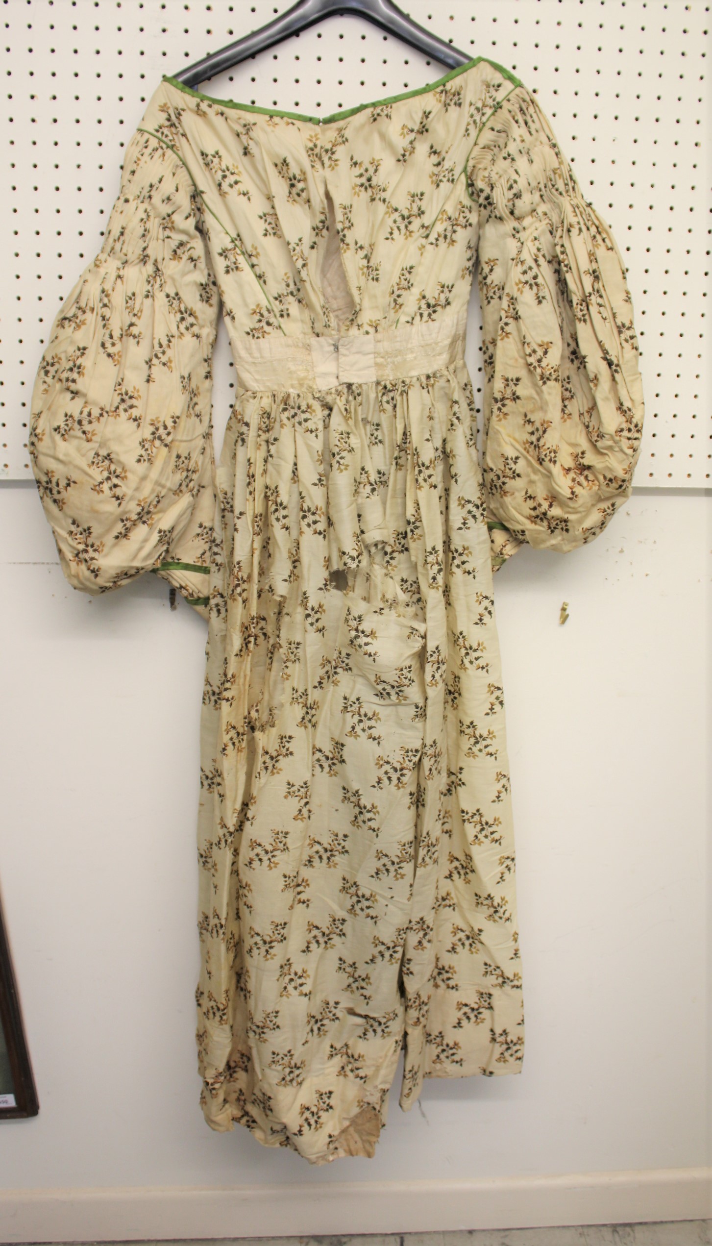 19THC CREAM SILK PATTERNED DAY DRESS with green silk ribbon detail, 123cms long. Also with a Paisley